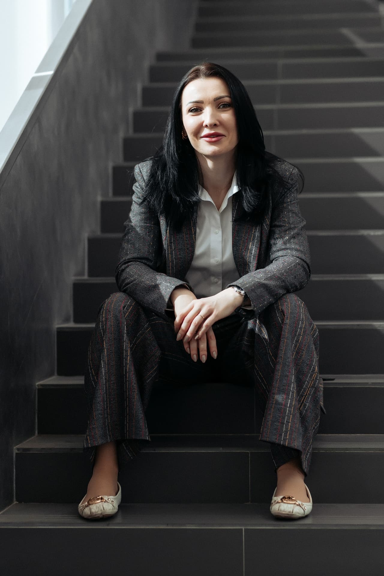 Daria Boiko seated on a staircase